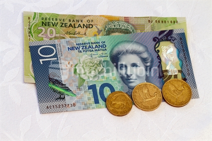 New $10 note released 2015, with an old $20 and some coins.  Note: Approved educational and commercial screen and print uses of NZ banknote images are detailed at: http://www.rbnz.govt.nz/notes_and_coins/issuing_or_reproducing/