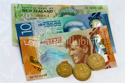 New $10 and $5 notes with an old $20 and some coins.  Note: Approved educational and commercial screen and print uses of NZ banknote images are detailed at: http://www.rbnz.govt.nz/notes_and_coins/issuing_or_reproducing/