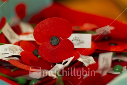 Box of ANZAC day remembrance poppies with out of focus background