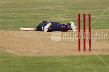 Batter on the ground on the cricket pitch