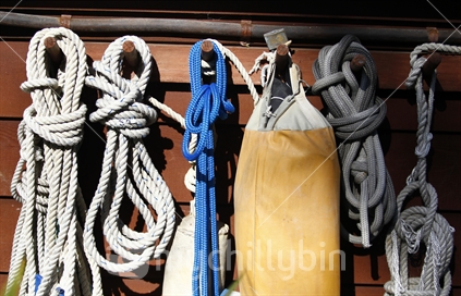 Marine rope hanks hanging on pegs.