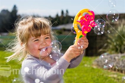 Girl having fun making bubbles. 