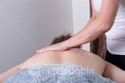 Massage threapist treating a patient. 