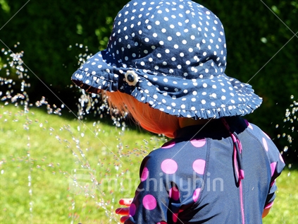 A young girl playing with water over the Christmas holidays.... Wanaka New Zealand
