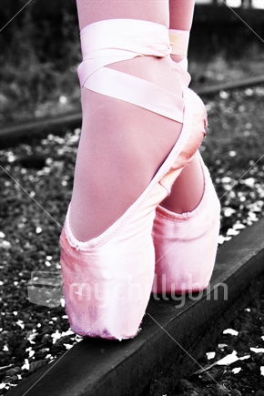 Pointe dancing shoes on train tracks