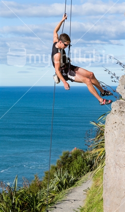 A rockclimber rappels down after reaching the top of a route on Mt Maunaganui in Tauranga