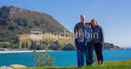 A family visiting Moturiki island with Mauao (Mt Maunganui) as the backdrop