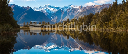 The native bush and mountains of the southern alps reflected in the still waters of Lake Matheson