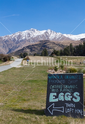A roadside sign entices passerby's to buy local free range eggs alongside Lake Wanaka