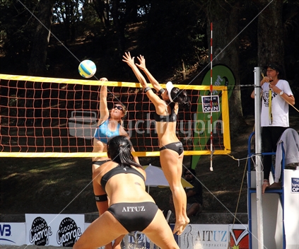 Women compete at net during Hamilton beach volleyball competition