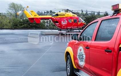 Emergency vehicle and helicopter on landing pad at Waikato Hospital
