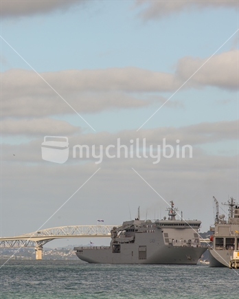 The NZ Royal Navy ship docking at the Devonport Naval base with the Auckland Harbour bridge in the background