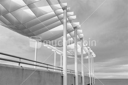 A monochrome side view of Napiers viewing platform overlooking the Pacific ocean.