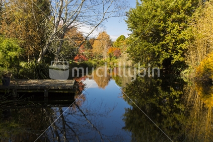 A serene setting where the beautiful autumn colours are reflected in a lake