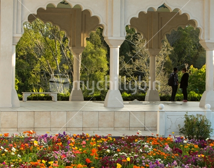 Arches frame the view for a couple admiring the Indian section of  Hamilton Gardens