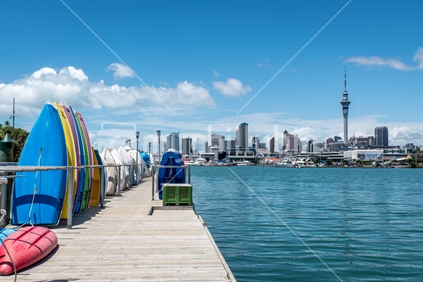 Dinghies on Westhaven pontoon with view of Auckland skyline