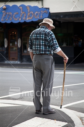 A man waiting to cross the road in Dunedin