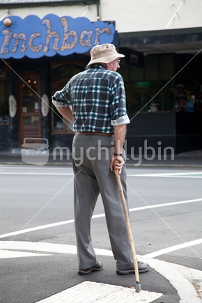 A man waiting to cross the road in Dunedin