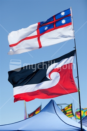 The Maori Sovereignty Flag and tthe Flag of the United Tribes of New Zealand Fly over Waitangi Day Celebrations