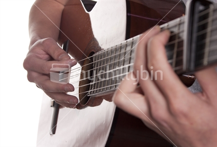 Close up of a man playing guitar.  