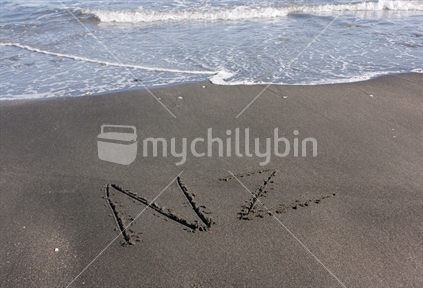 NZ written in the beach sand