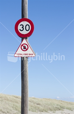 "Total fire ban" and 30kms speed limit sign on beach