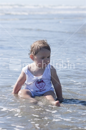 Toddler playing in the water at beach