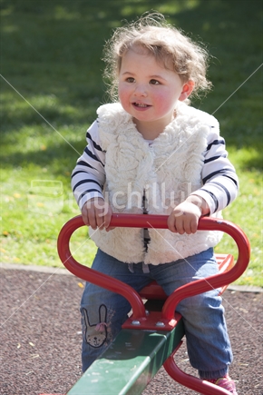 Little girl on see saw