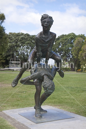 Sculpture of children leap frogging.  