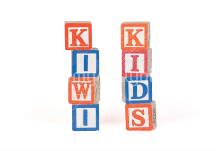 Kiwi Kids spelled in toy letter blocks isolated on white