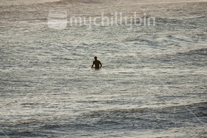 Lone surfer waiting for a wave