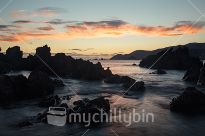 Long exposure of a sunset over rocks, coastal Wellington.