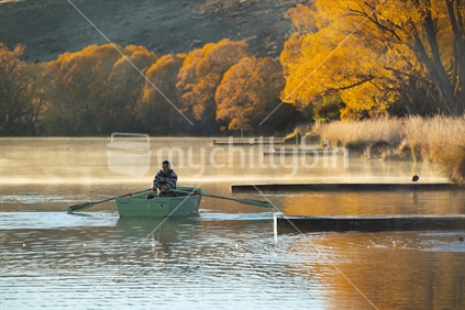 Fisherman in a boat on the lake (1 of 2)
