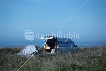 Campervan and tent by the ocean