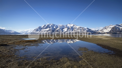 Reflection of snow-capped mountain near Lake Hawea