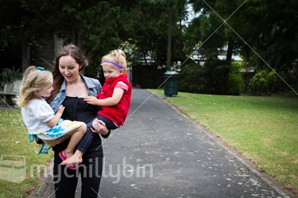 Young mother and two girls in the park