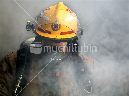 Fireman, in the smoke whilst fighting a house fire. 