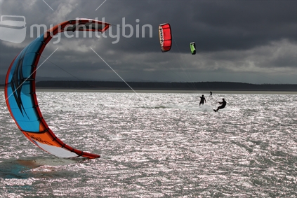A couple of kite surfers in Nelson with dark sky