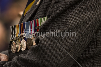 Close up of war hero with a line of medals pinned on jacket.