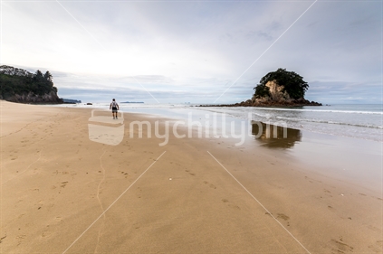 Walker on a pristine Coromandel beach