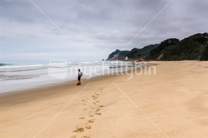 Walker on a pristine Coromandel beach