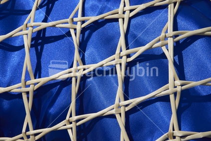 Maori flax weaving - detailed view of a kupenga knot kete with royal blue lining