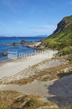 Closeup of Ocean Beach with white sand and rocky coastline, Whangarei Heads, Northland