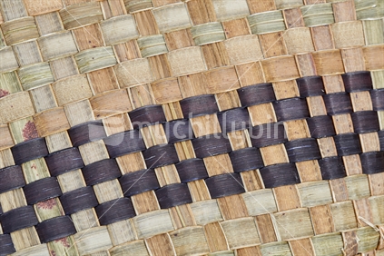 Maori flax weaving - closeup of a kete with dyed and natural strands
