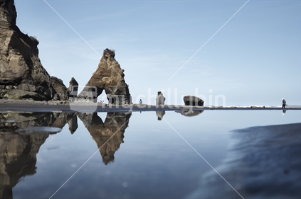Three Sisters rock formations and reflections at Tongaporutu Beach near Mokau, Taranaki
