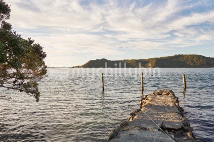 Old Houhora Heads harbour wharf at sunset on Northland's Aupouri Peninsula
