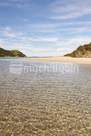 Sunshine in crystal clear water at the Houhora Heads' East Beach on Northland's Aupouri Peninsula