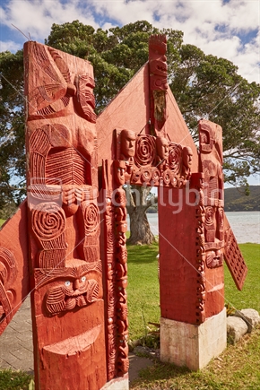 Carved Maori waharoa gate welcoming visitors at the Houhora Heads in the Far North