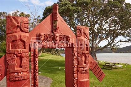 Carved Maori waharoa gate welcoming visitors at the Houhora Heads in the Far North