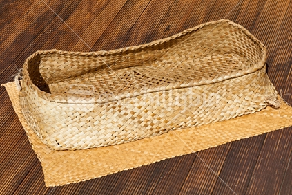 Flax weaving - Wahakura, traditional woven sleeping cot for babies used by Maori families to keep children safe in bed